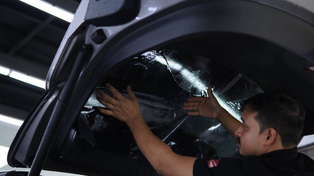 Installer fitting tint from inside a Xiaomi YU7 Max