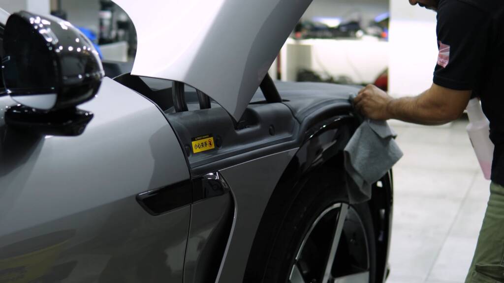 Detailer preparing the front wing of a Xiaomi YU7 Max for ceramic coating